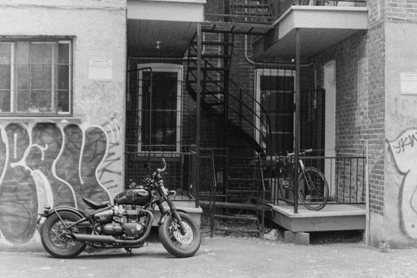 Parked Motorbike In A Montreal Alleyway In Black And White by Normand Charpentier